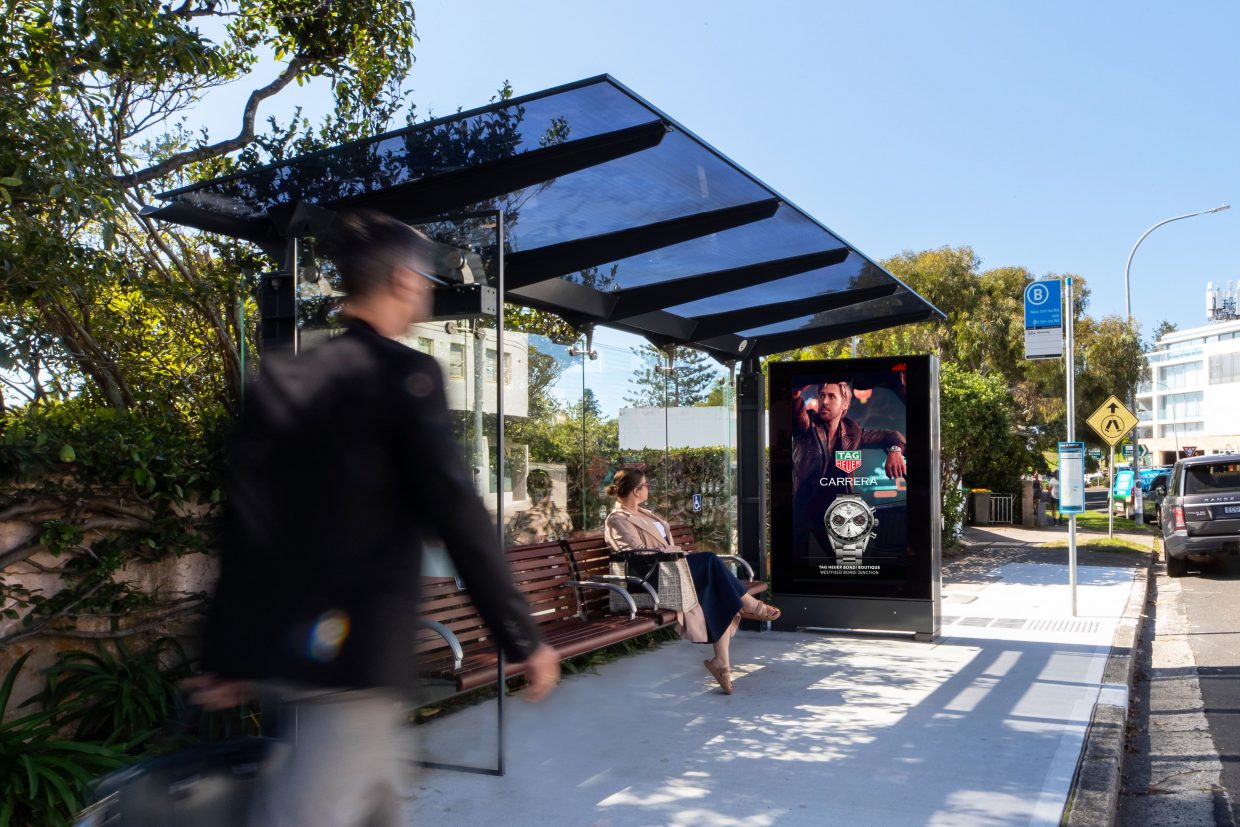 Digital street furniture bus stop advertising featuring Tag Heuer creative