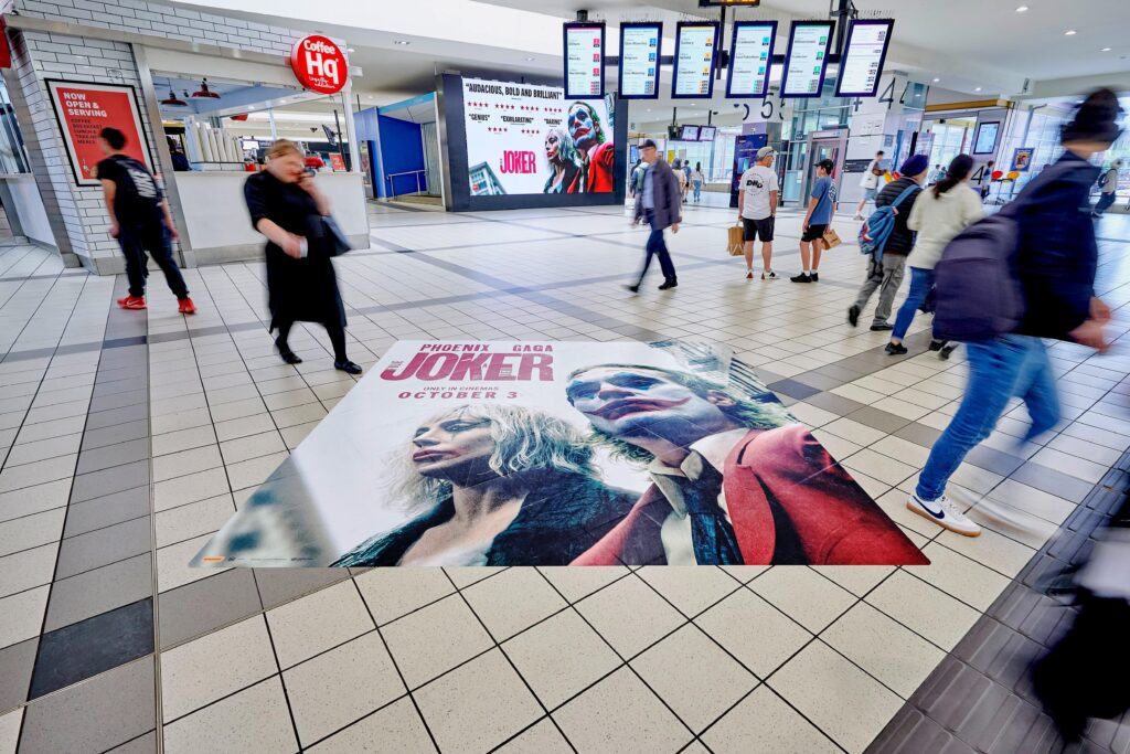 Digital train station advertising and floor decals in Melbourne, The Joker