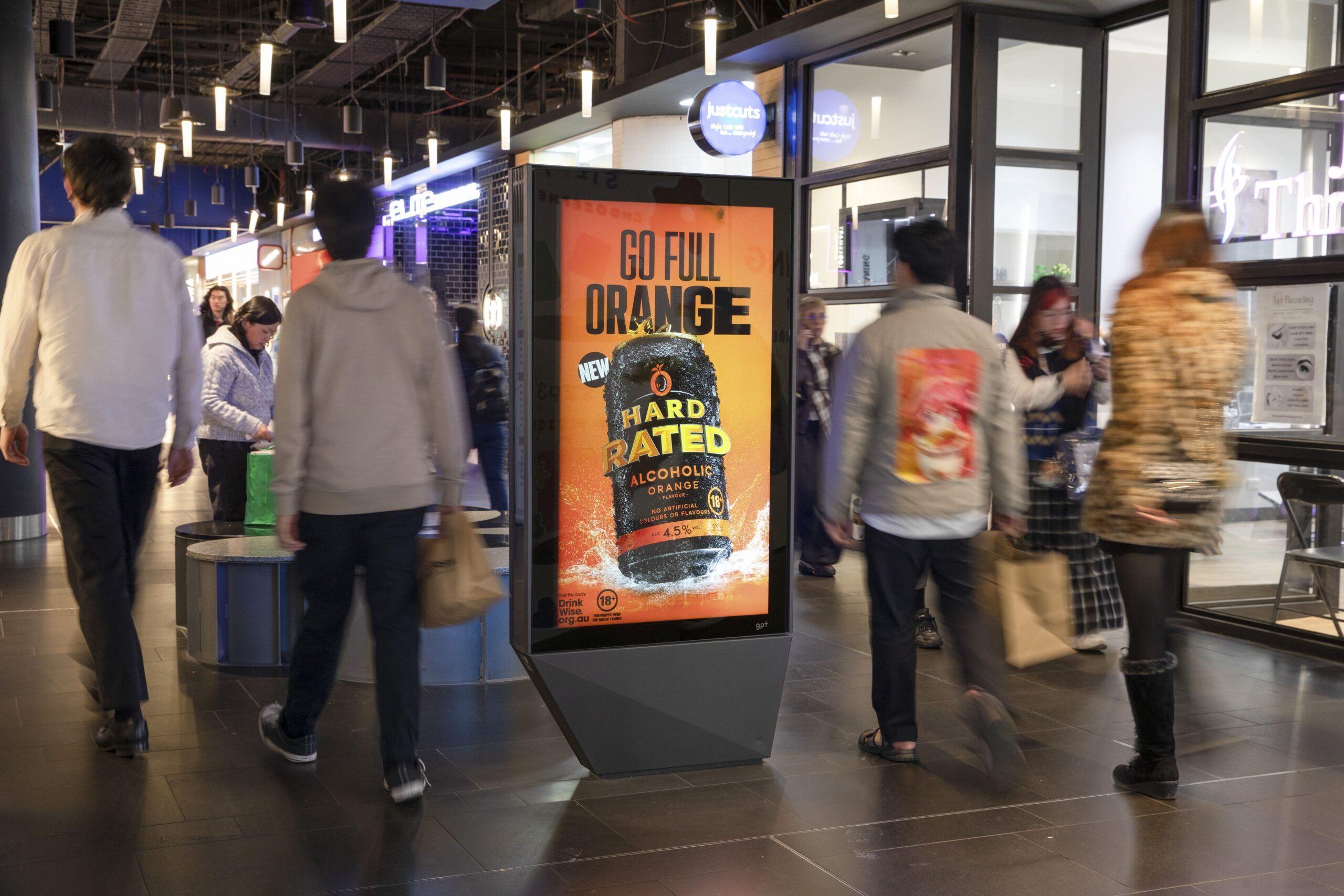Digital advertising screen in Melbourne Central retail centre, featuring Asahi Hard Rated creative