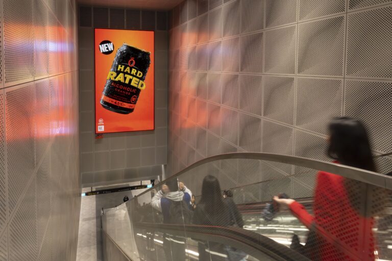 Digital advertising screen in Sydney Metro, Asahi Hard Rated creative