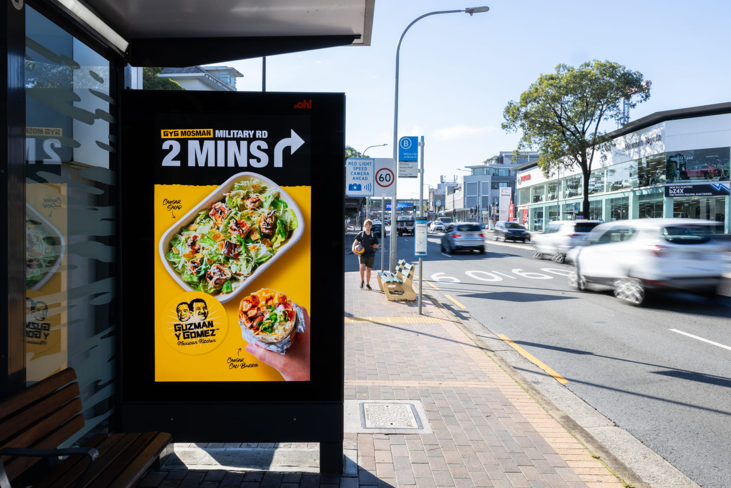 Digital advertising bus shelter screen featuring Guzman Y Gomez creative