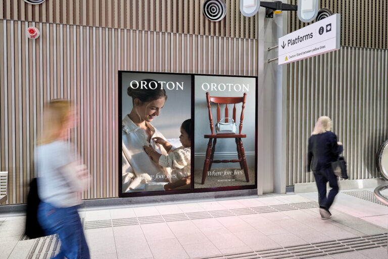 Digital advertising screen in Melbourne Metro tunnel station, featuring Oroton creative